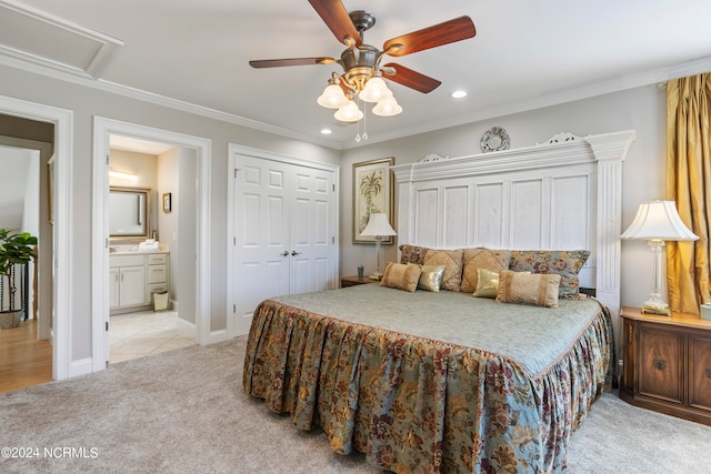 carpeted bedroom with ceiling fan, crown molding, ensuite bathroom, and a closet