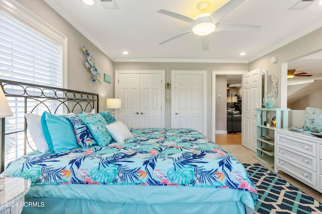 bedroom with crown molding, a closet, ceiling fan, and multiple windows