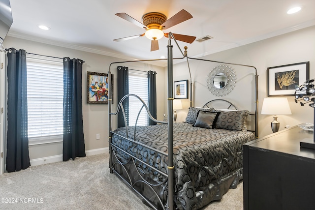 carpeted bedroom featuring ceiling fan and ornamental molding