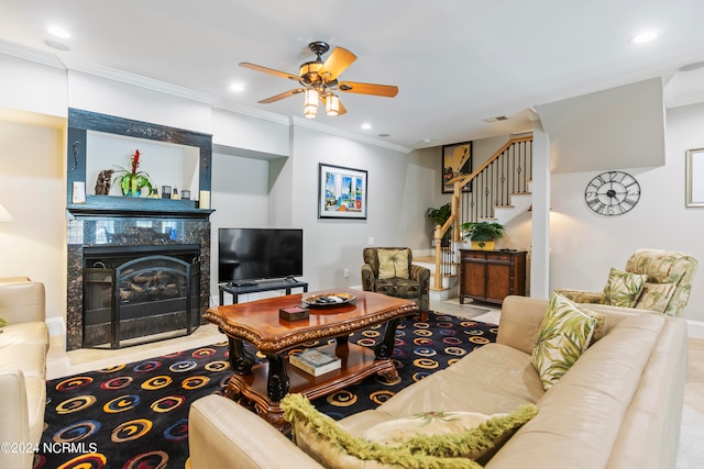 carpeted living room featuring ornamental molding, a fireplace, and ceiling fan