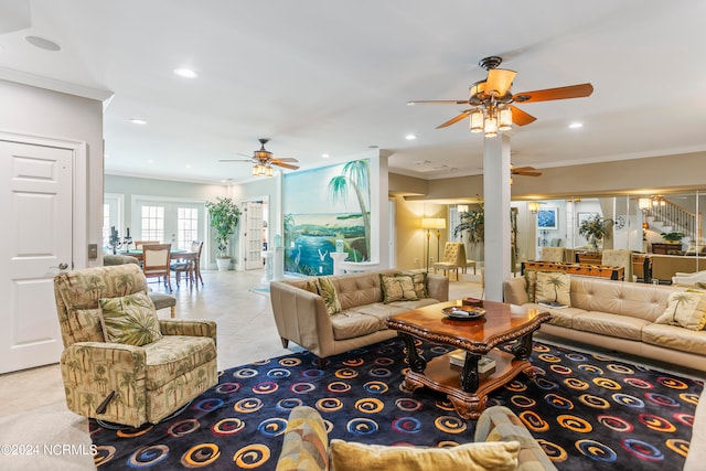 living room with ceiling fan, ornamental molding, and light tile floors