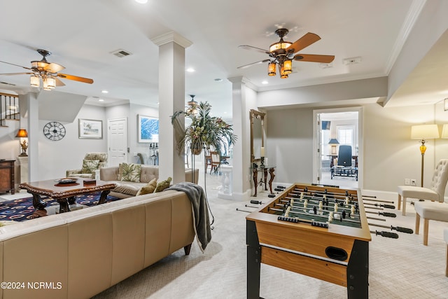 carpeted living room with ceiling fan and ornamental molding