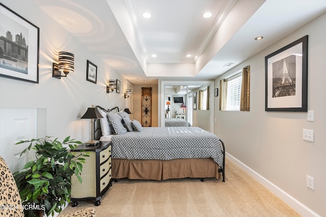 bedroom featuring a raised ceiling, ornamental molding, and light carpet