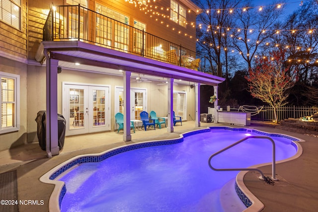 view of swimming pool with a patio area and french doors