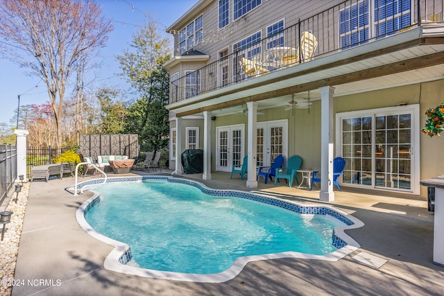 view of swimming pool with a patio, ceiling fan, area for grilling, and french doors