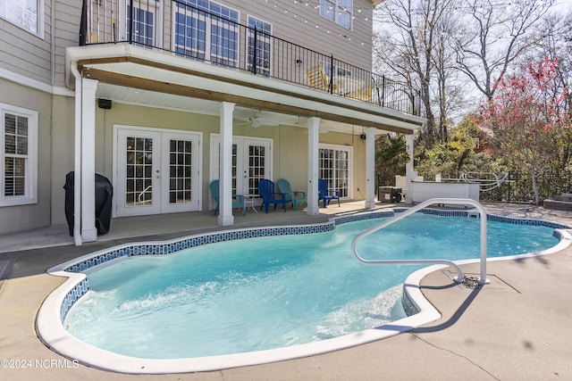 view of pool featuring french doors, a patio area, and ceiling fan