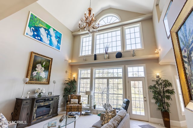 living room with high vaulted ceiling and an inviting chandelier