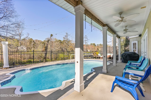 view of swimming pool featuring ceiling fan, grilling area, and a patio area