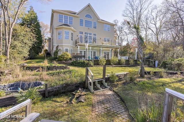 rear view of property featuring a lawn