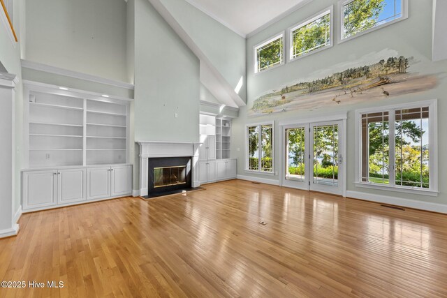 dining area with light wood-type flooring, ornamental molding, and a chandelier