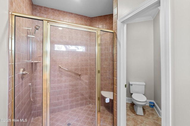 bathroom featuring tile patterned flooring, toilet, and a shower with shower door