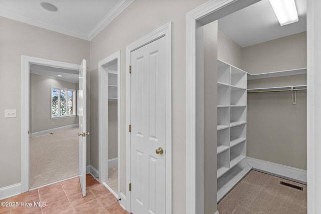 interior space featuring crown molding and tile patterned flooring