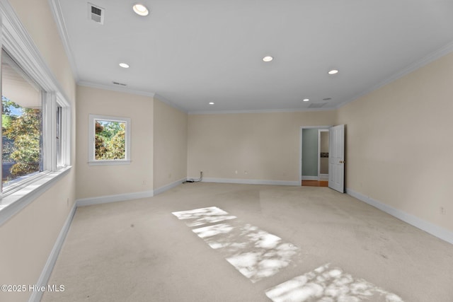 unfurnished room with ornamental molding and light colored carpet