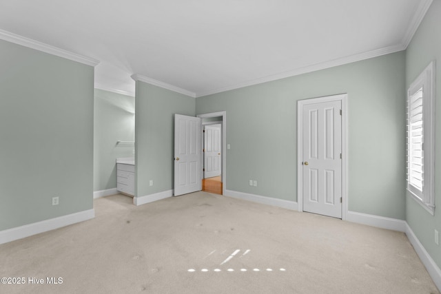 unfurnished bedroom with light carpet, crown molding, and connected bathroom