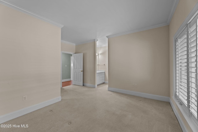 carpeted spare room featuring ornamental molding