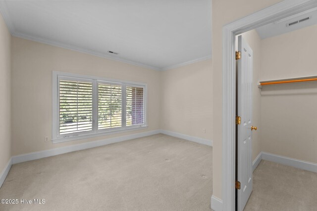 unfurnished bedroom with light carpet and crown molding