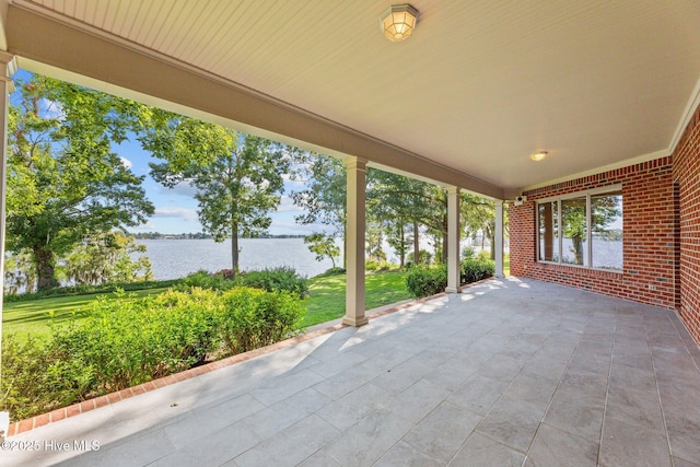 view of patio with a water view