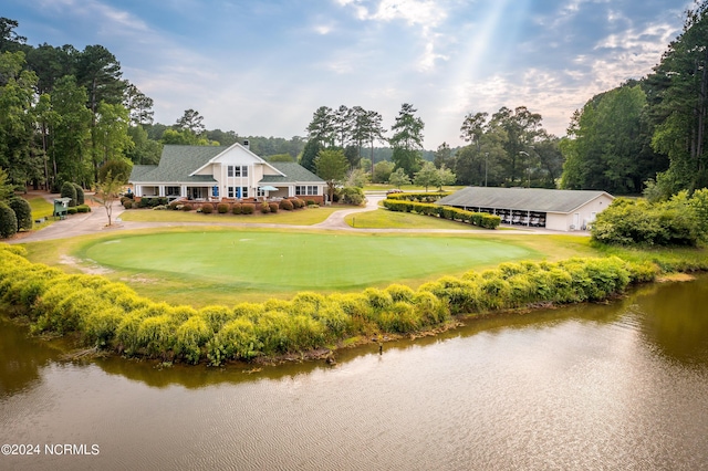 view of home's community with a lawn and a water view