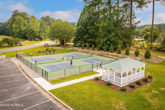 view of sport court featuring a lawn and a gazebo