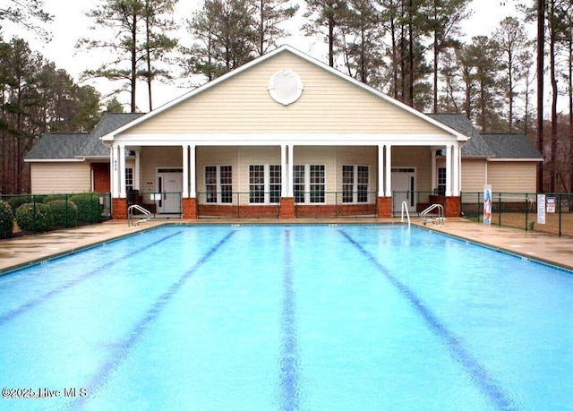 view of pool with a patio and an outdoor structure