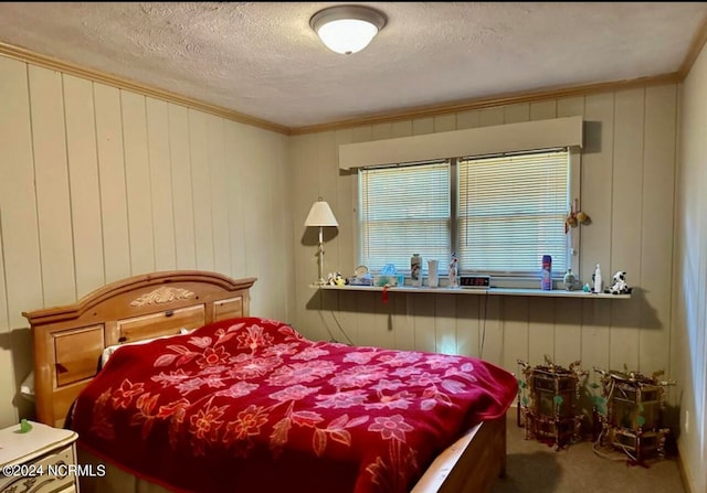 bedroom featuring carpet, a textured ceiling, and crown molding