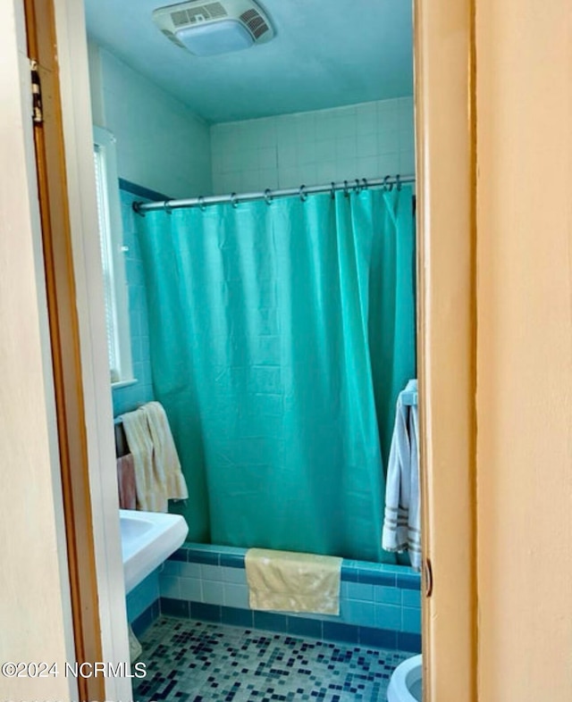 bathroom featuring toilet and tile floors