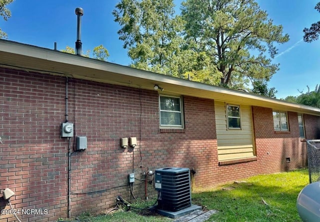 view of side of property featuring central air condition unit