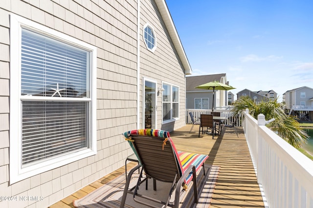 wooden terrace featuring outdoor dining area