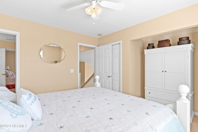 bedroom featuring ceiling fan and a closet