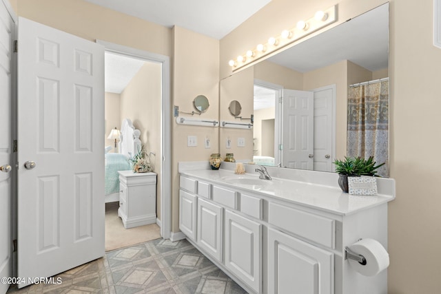 bathroom featuring tile patterned floors, connected bathroom, and vanity