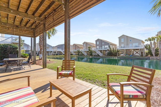 view of patio with a deck with water view and a residential view