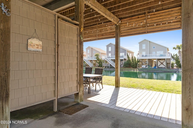 entryway with concrete flooring and a water view