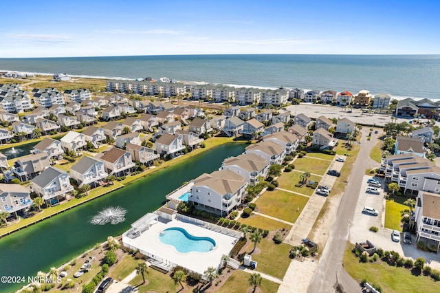 drone / aerial view with a water view and a residential view