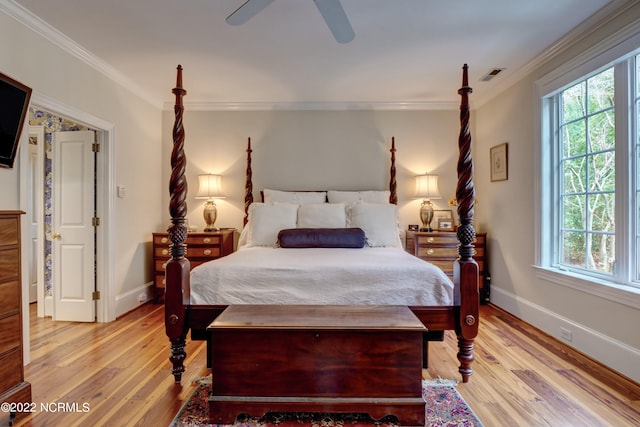 bedroom featuring light hardwood / wood-style flooring, ceiling fan, and ornamental molding