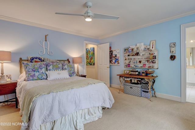 bedroom featuring ceiling fan, ornamental molding, light carpet, and ensuite bathroom