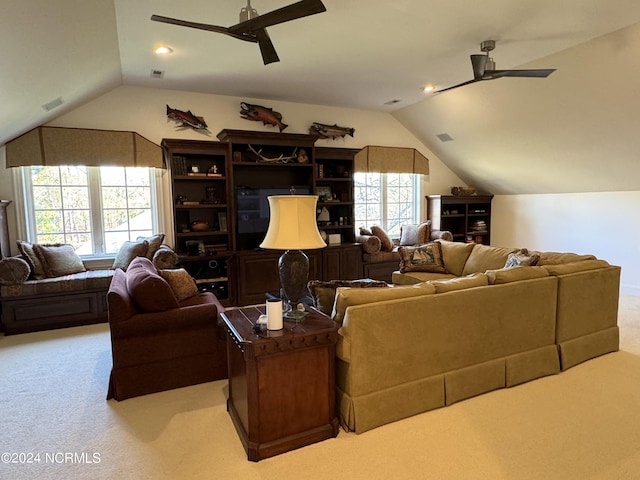 carpeted living room with ceiling fan and lofted ceiling