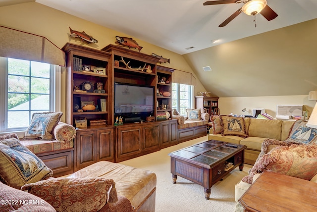 living room with ceiling fan, light carpet, and lofted ceiling