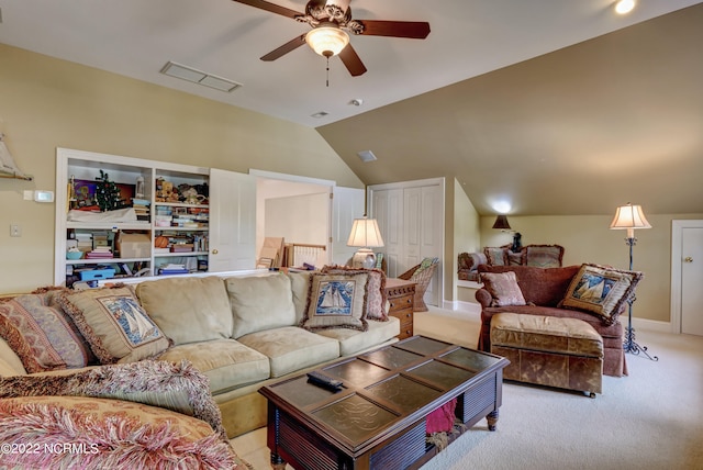 carpeted living room with vaulted ceiling, built in shelves, and ceiling fan