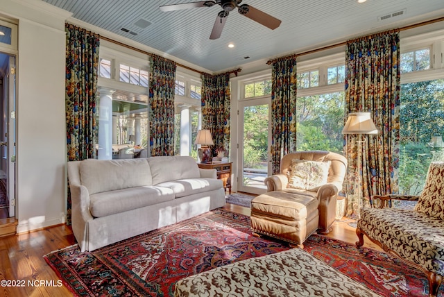 living room with ceiling fan, dark wood-type flooring, and ornamental molding