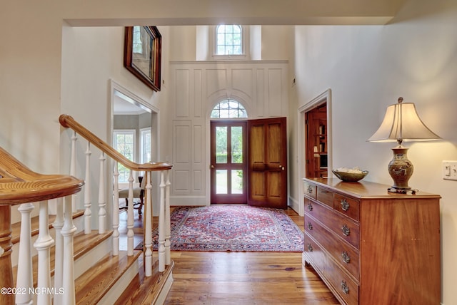 foyer featuring hardwood / wood-style flooring and a high ceiling