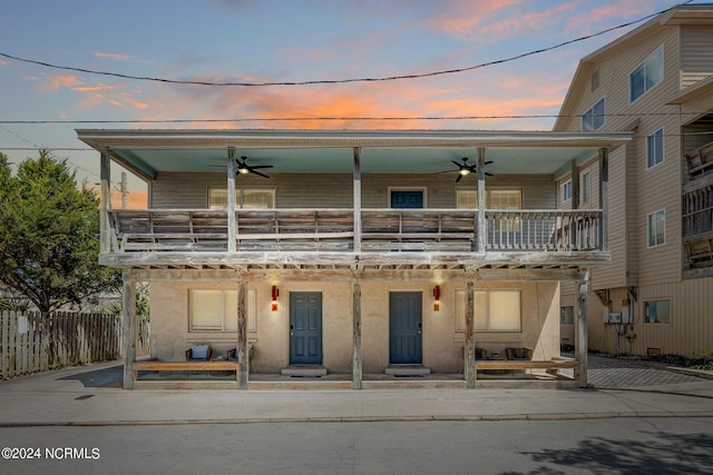 view of front facade with a patio area, a balcony, and ceiling fan