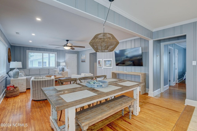 kitchen featuring crown molding, stainless steel appliances, light tile floors, a center island, and a breakfast bar