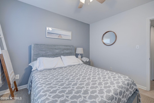 bedroom featuring ceiling fan and light tile floors