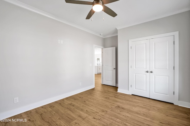 unfurnished bedroom featuring light hardwood / wood-style flooring, ornamental molding, a closet, and ceiling fan