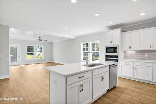 kitchen with a center island with sink, sink, stainless steel dishwasher, ceiling fan, and built in microwave