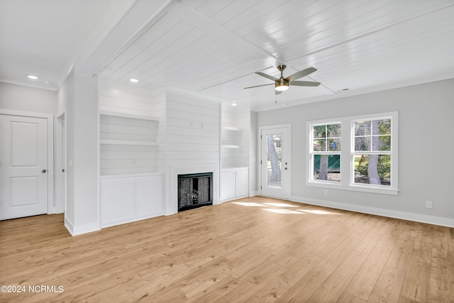 unfurnished living room featuring light hardwood / wood-style flooring, ceiling fan, a fireplace, built in shelves, and wooden ceiling