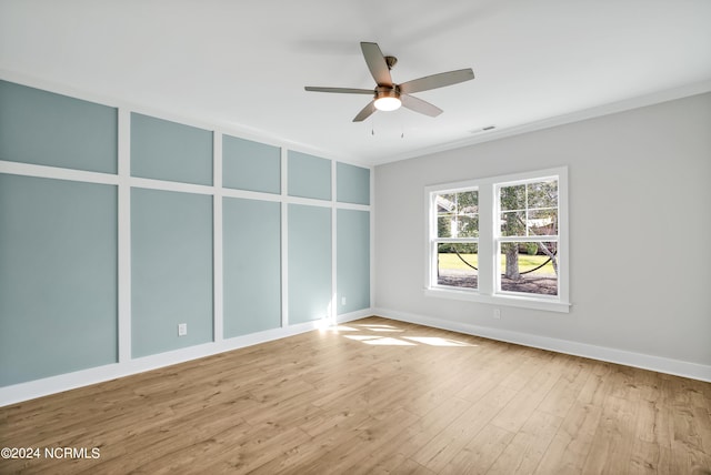 empty room with crown molding, ceiling fan, and light hardwood / wood-style floors