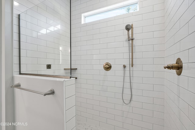 bathroom with tiled shower