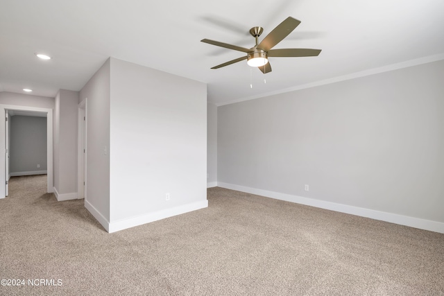 carpeted empty room with crown molding and ceiling fan