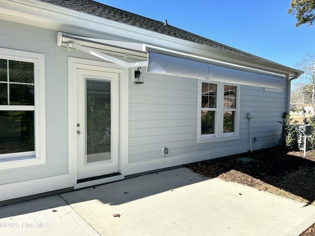 property entrance featuring a patio area